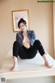 A woman sitting on top of a white table.