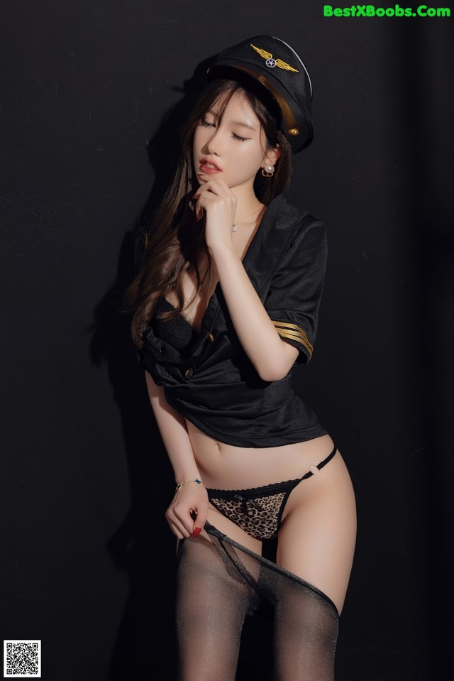 A woman in a black shirt and a black hat.