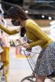 A woman wearing a face mask is shopping in a grocery store.