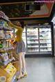 A woman wearing a face mask is shopping in a grocery store.