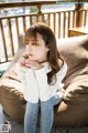 a woman sitting on top of a brown couch