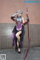 A woman dressed in a costume holding a sword.