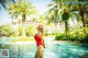 A woman in a red bathing suit standing in a pool.