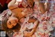 A woman laying on top of a bed covered in money.