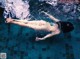 A man swimming in a pool with the words WANIMAL written on it.