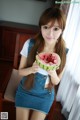 A woman holding a slice of watermelon in her hand.