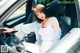 A woman sitting in the driver's seat of a car.