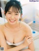 a japanese woman in a white bra top is posing for the camera